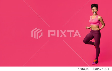 Happy fitness black girl exercising over red background, gym concept 130575004