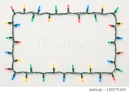 Festive String of Multicolored Christmas Lights Pure White Background Holiday Frame Cheerful Environment Seasonal Concept Festive String of Multicolored Christmas Lights Pure White Background Holiday Frame Cheerful Environment Seasonal Concept 130575104