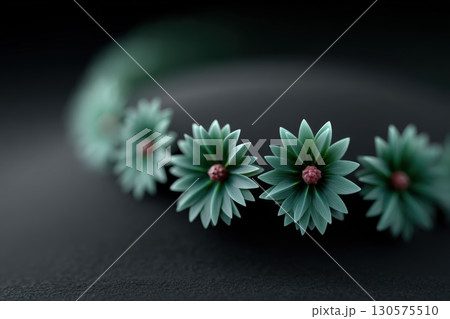 Beautiful handcrafted floral crown made of green materials displayed against a dark background 130575510