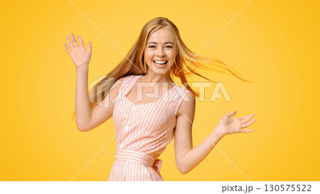 Cheerful Teen Girl With Natural Blonde Hair Posing Over Yellow Background, Smiling And Looking At Camera, Copy Space Cheerful Teen Girl With Natural Blonde Hair Posing Over Yellow Background, Smiling And Looking At Camera, Copy Space 130575522