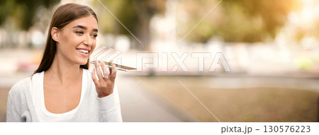 Modern technologies. Woman using digital voice assistant on cellphone outdoor, empty space Modern technologies. Woman using digital voice assistant on cellphone outdoor, empty space 130576223