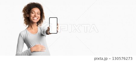 Pregnancy applications. Afro lady showing cellphone with empty screen over white background 130576273