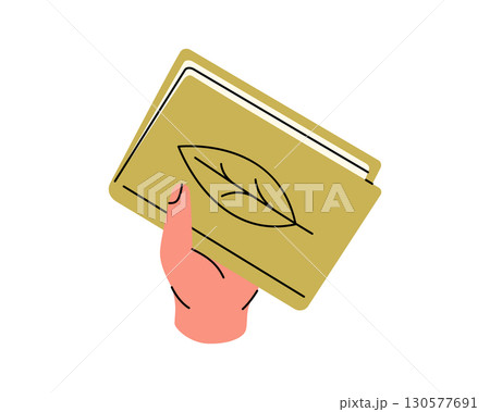 Hand holding a yellow book with a leaf symbol on the cover. Clean vector design for eco and reading themes 130577691