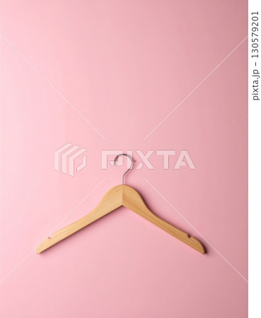 Wooden Hanger on Pink Background Wooden Hanger on Pink Background 130579201