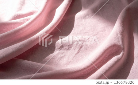 Soft Pink Velvet Fabric Draped with Gentle Light and Shadow 130579320