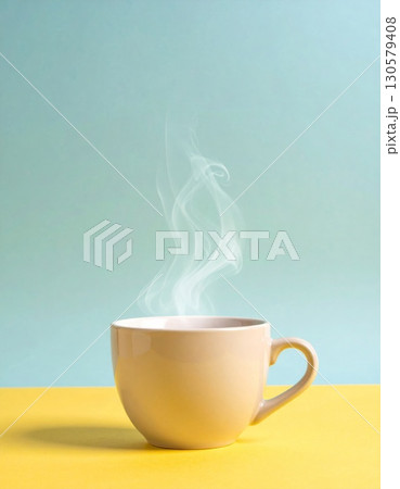 Beige Cup of Steaming Tea on Yellow and Blue Background 130579408