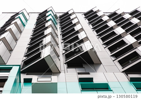 High-rise apartment buildings in a residential area with modern architecture and unique balcony 130580119