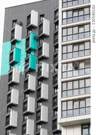 Modern high-rise apartment buildings in a residential area showcasing unique architectural designs 130580182