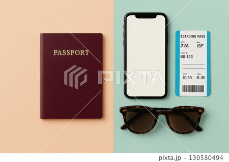Travel essentials including a passport, smartphone, boarding pass, and sunglasses prepared for a journey on a pastel backdrop 130580494