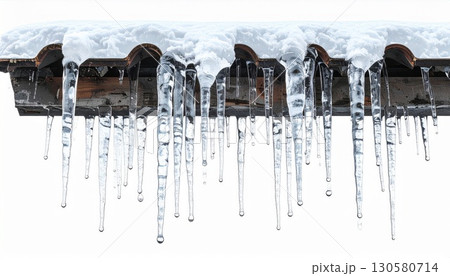 Icicles Hanging From Snowy Roof in Winter 130580714