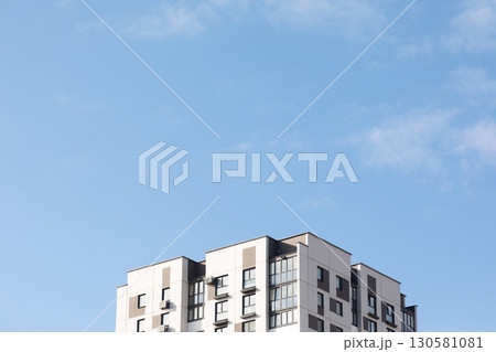 Modern high-rise apartment buildings under a blue sky in a bustling residential area focused on Modern high-rise apartment buildings under a blue sky in a bustling residential area focused on 130581081