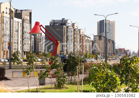 Modern high-rise apartment buildings in a bustling residential area with vibrant greenery and urban Modern high-rise apartment buildings in a bustling residential area with vibrant greenery and urban 130581082