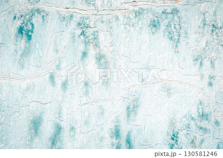 Macro fragment of an old surface with cracked paint structure. Texture of a metal sheet painted white and blue. Multilayered, worn surface. 130581246