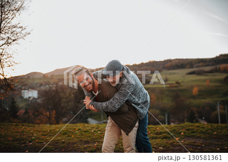 Senior father and his son walking in nature, having fun. 130581361