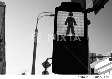 Pedestrian signal in black and white, emphasizing importance of road safety and traffic regulations. Image captures stillness and importance of waiting for the signal in urban environment 130582136