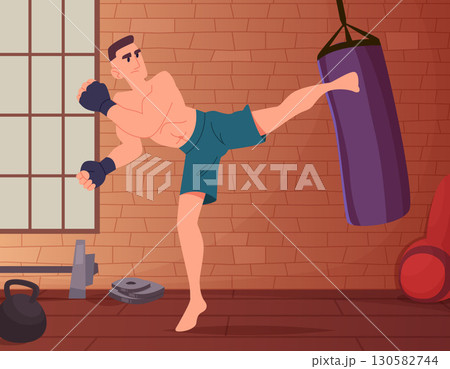 Martial arts training. aggressive man leg kicks sports bag in training room 130582744