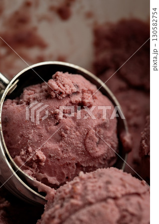 Creamy raspberry ice cream scoops in close-up, rich texture and vibrant pink color Creamy raspberry ice cream scoops in close-up, rich texture and vibrant pink color 130582754