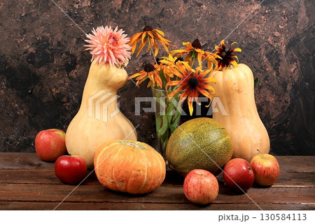 Happy Thanksgiving concept, autumn background with seasonal pumpkins, melons, apples and flowers on an old wooden background, copy space, selective focus. Happy Thanksgiving concept, autumn background with seasonal pumpkins, melons, apples and flowers on an old wooden background, copy space, selective focus. 130584113