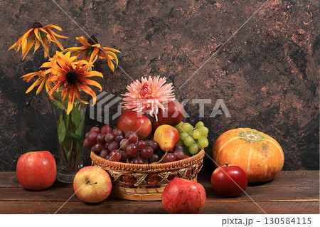 Autumn harvest concept, old wooden table with pumpkins, melons, apples, pears and grapes, thanksgiving day background, healthy ecological food, rustic style, selective focus Autumn harvest concept, old wooden table with pumpkins, melons, apples, pears and grapes, thanksgiving day background, healthy ecological food, rustic style, selective focus 130584115