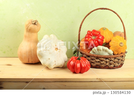 A variety of selection pumpkins, squash and tomatoes on a wooden table. Autumn composition with gifts of nature, thanksgiving day concept, harvesting, banner or splash, postcard, A variety of selection pumpkins, squash and tomatoes on a wooden table. Autumn composition with gifts of nature, thanksgiving day concept, harvesting, banner or splash, postcard, 130584130