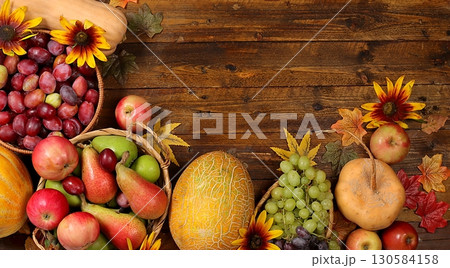 Happy Thanksgiving concept, fall background with seasonal fall berries, pumpkins, melons, apples, grapes and flowers on wooden background, harvesting in the village, Happy Thanksgiving concept, fall background with seasonal fall berries, pumpkins, melons, apples, grapes and flowers on wooden background, harvesting in the village, 130584158