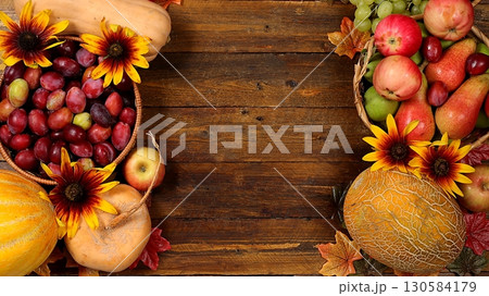 Autumn still life with apples, rowan berries, pumpkins, sunflower flowers on an old wooden table, background, Thanksgiving concept, rustic harvest, healthy natural food concept, 130584179