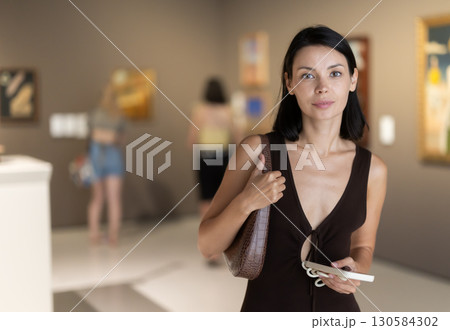 Young woman at a sculpture exhibition Young woman at a sculpture exhibition 130584302