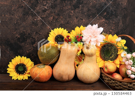 Happy Thanksgiving concept, autumn background with seasonal pumpkins, melons, apples and flowers on an old wooden background, copy space, selective focus. 130584463