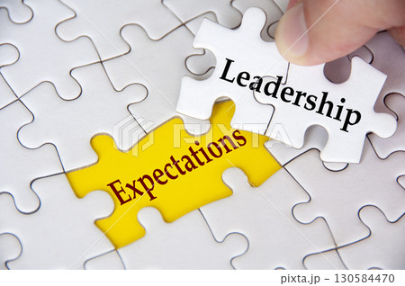 Leadership Expectations, Jigsaw puzzle with missing piece showing the text Leadership Expectations highlighted in focus. Leadership Expectations, Jigsaw puzzle with missing piece showing the text Leadership Expectations highlighted in focus. 130584470
