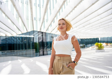 Confident businesswoman with short blond hair 130584753