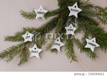 Christmas star with words RISEN BLESSED HOPE JOY PEACE DREAM LOVE WONDER White air dry clay for making decor to Christmas tree holiday. Creating hobby recreation activity that involves fingers. DIY Christmas star with words RISEN BLESSED HOPE JOY PEACE DREAM LOVE WONDER White air dry clay for making decor to Christmas tree holiday. Creating hobby recreation activity that involves fingers. DIY 130584822