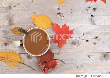 Autumn drink, seasonal composition, hot coffee with cinnamon in iron mugs on wooden background, copy space, Happy thanksgiving concept, greeting card, flat lay Autumn drink, seasonal composition, hot coffee with cinnamon in iron mugs on wooden background, copy space, Happy thanksgiving concept, greeting card, flat lay 130584898