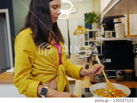 Young woman is broadcasting live from workshop how to prepare a vegetarian food Young woman is broadcasting live from workshop how to prepare a vegetarian food 130587123