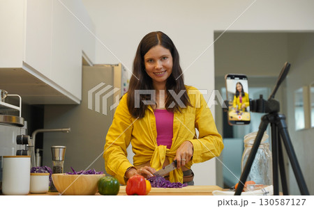 Young woman is broadcasting live from workshop how to prepare a vegetarian food 130587127