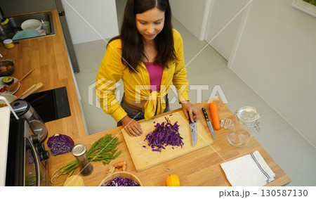 Young woman is broadcasting live from workshop how to prepare a vegetarian food Young woman is broadcasting live from workshop how to prepare a vegetarian food 130587130