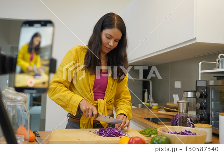 Young woman is broadcasting live from workshop how to prepare a vegetarian food 130587340