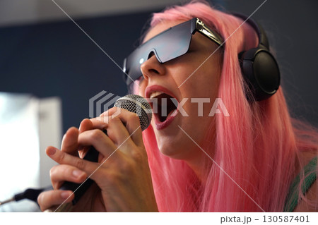 Beautiful young singer and musician broadcast from her home studio Beautiful young singer and musician broadcast from her home studio 130587401