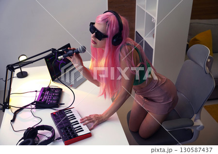 Beautiful young singer and musician broadcast from her home studio Beautiful young singer and musician broadcast from her home studio 130587437