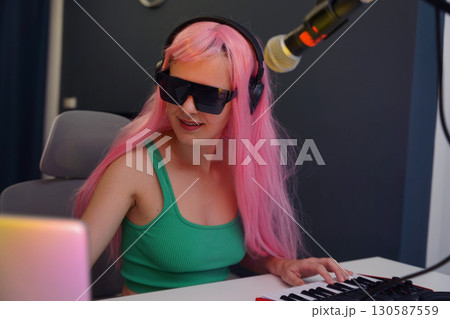 Beautiful young singer and musician broadcast from her home studio Beautiful young singer and musician broadcast from her home studio 130587559