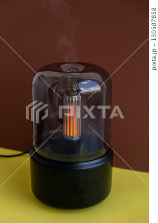 Indoors Decoration with modern lighted Air Humidification Aroma essential oil perfume fragrance. Scented home wellness wellbeing habit. Concept of feeling good spiritual health 130587858