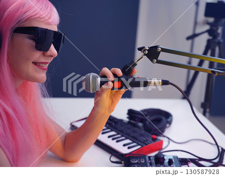 Beautiful young singer and musician broadcast from her home studio Beautiful young singer and musician broadcast from her home studio 130587928