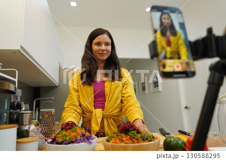 Young woman is broadcasting live from workshop how to prepare a vegetarian food 130588295