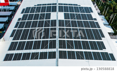Energy efficient rooftop with multiple solar panels installed on a contemporary mall 130588818