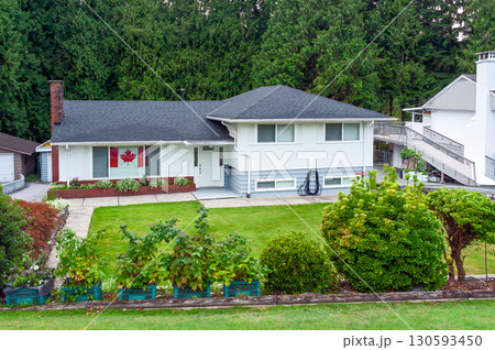 A perfect neighbourhood. Family residential house with canadian flag A perfect neighbourhood. Family residential house with canadian flag 130593450