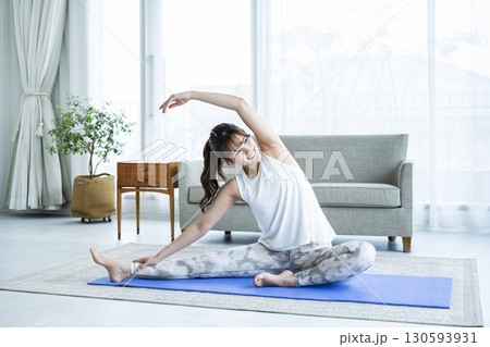 自宅でトレーニングする若い女性 130593931