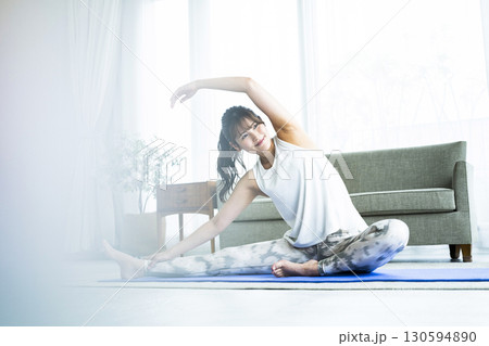 自宅でトレーニングする若い女性 130594890