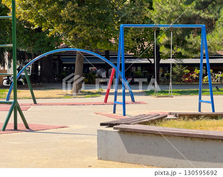 Empty playground with swings and climbing frames. Urban infrastructure and childhood leisure. Empty playground with swings and climbing frames. Urban infrastructure and childhood leisure. 130595692