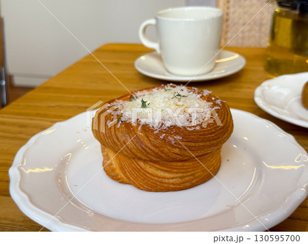 Gourmet pastry with grated cheese and herbs on a plate. Culinary presentation and fine dining. Gourmet pastry with grated cheese and herbs on a plate. Culinary presentation and fine dining. 130595700