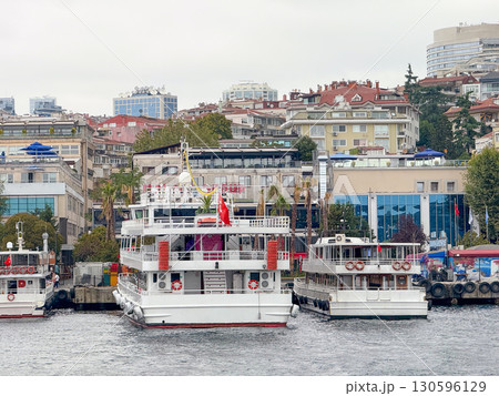 Passenger ferry with Turkish flag at pier in Istanbul. Urban life, transport and Bosphorus maritime culture. Passenger ferry with Turkish flag at pier in Istanbul. Urban life, transport and Bosphorus maritime culture. 130596129