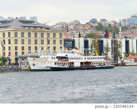 Ferry moored near Shangri-La hotel in Istanbul. Maritime transport, urban waterfront and Bosphorus passenger connection. 130596134